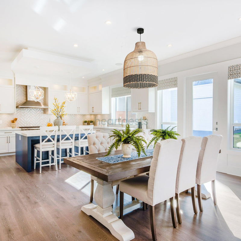 Heartnests's Ayla rattan hanging light is hung above a dining table with 6 dining chairs in a large living room with 3 window and wooden floor, inspired by contemporary decor style