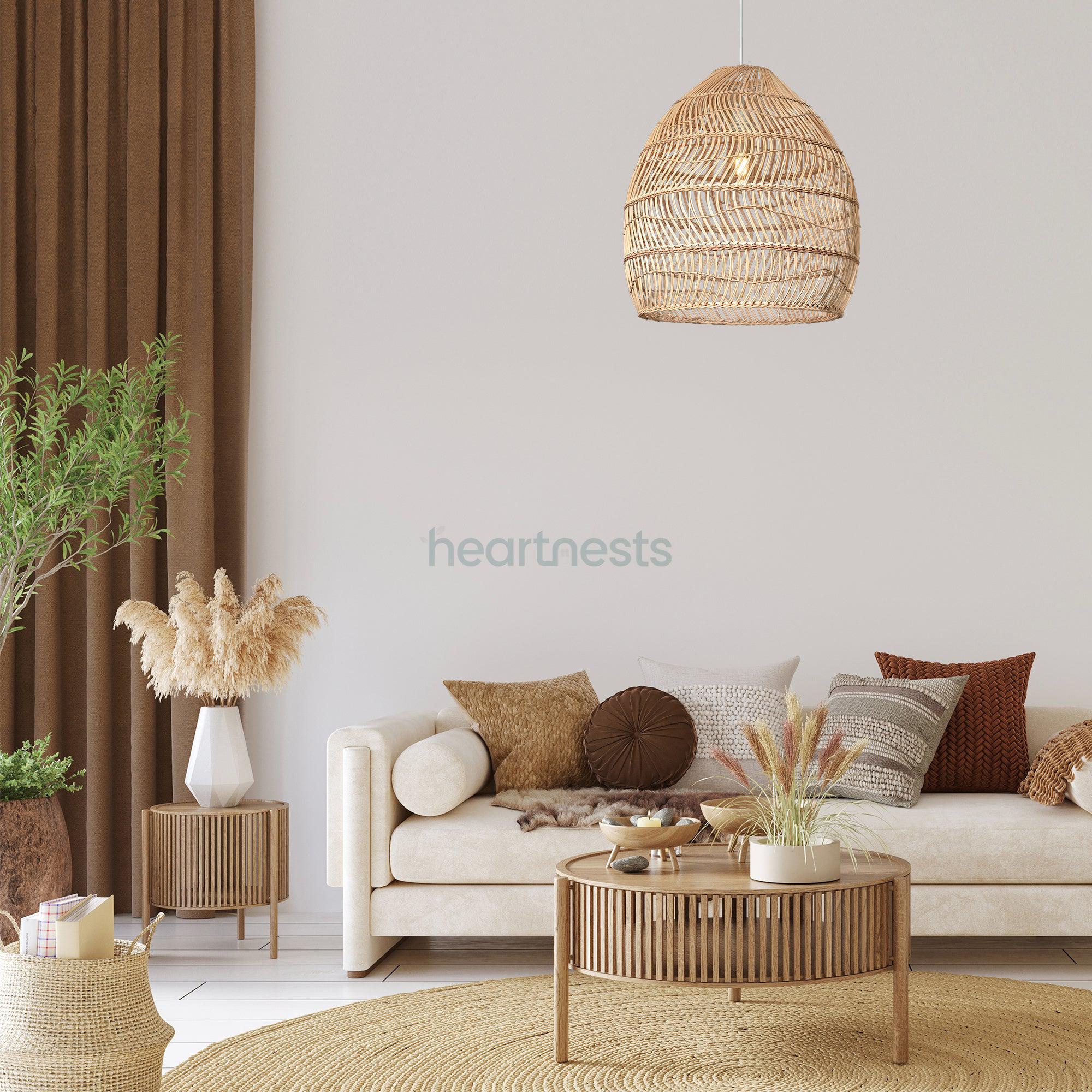 A Heart Nests's Acacia rattan pendant light is hung above a white 2 seater sofa and a round rattan table in a simple boho living room