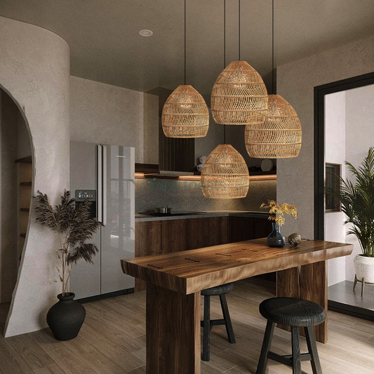 4 of Heart Nests's Acacia Rattan Pendant Light are hung in a cluster over a rustic wooden kitchen island in a modern kitchen area with a pot plant and a refrigerator 