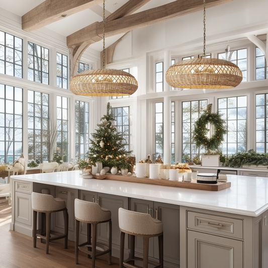Two of Heart Nests's Almafi rattan pendant light are hung side by side over a while marble top kitchen island with 3 contempory style kitchen stools. The kitchen area is luxurious with holiday vibe