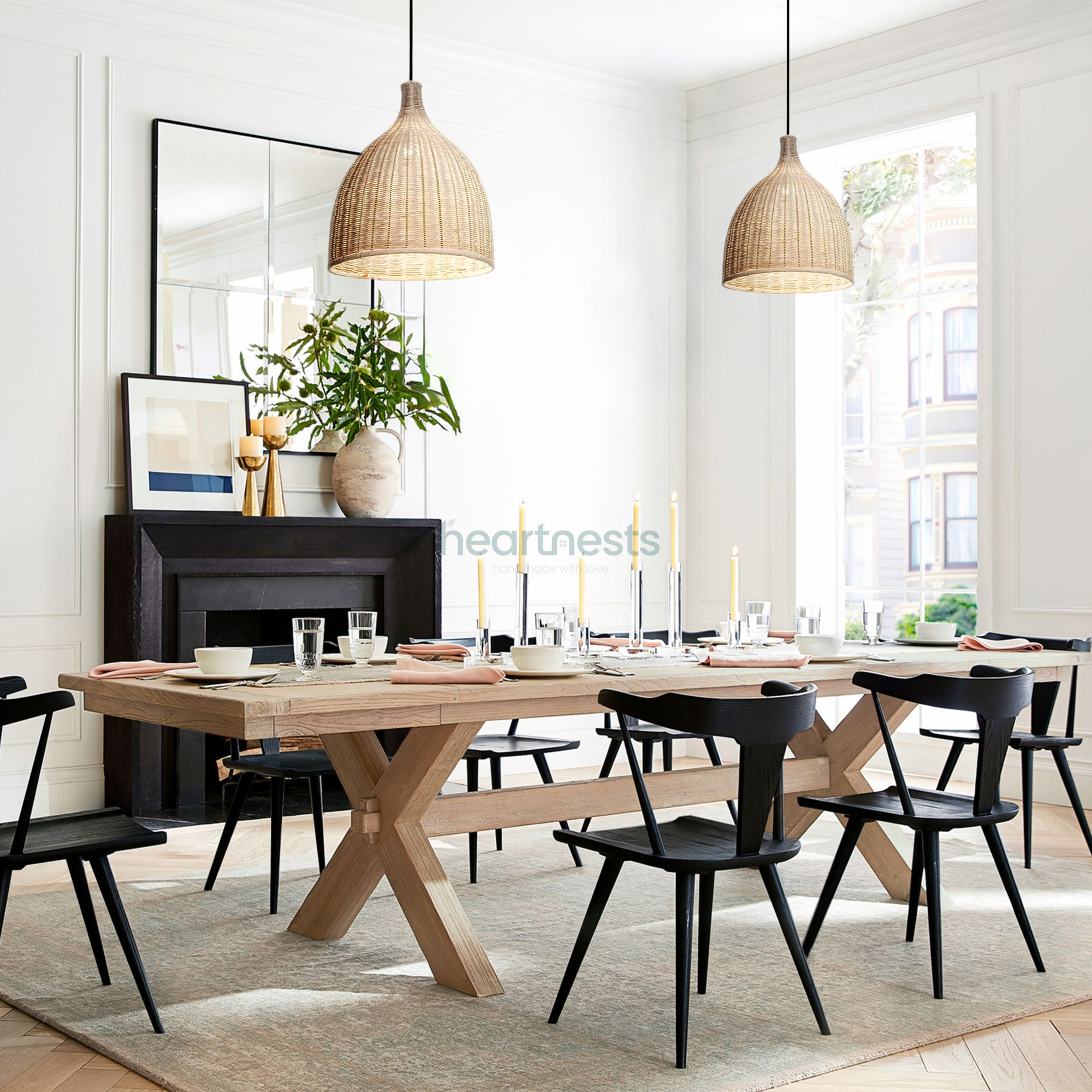 2 Baleria wicker hanging lights are hung side by side over a large dining wooden table with 2 dark oak tone wooden chairs