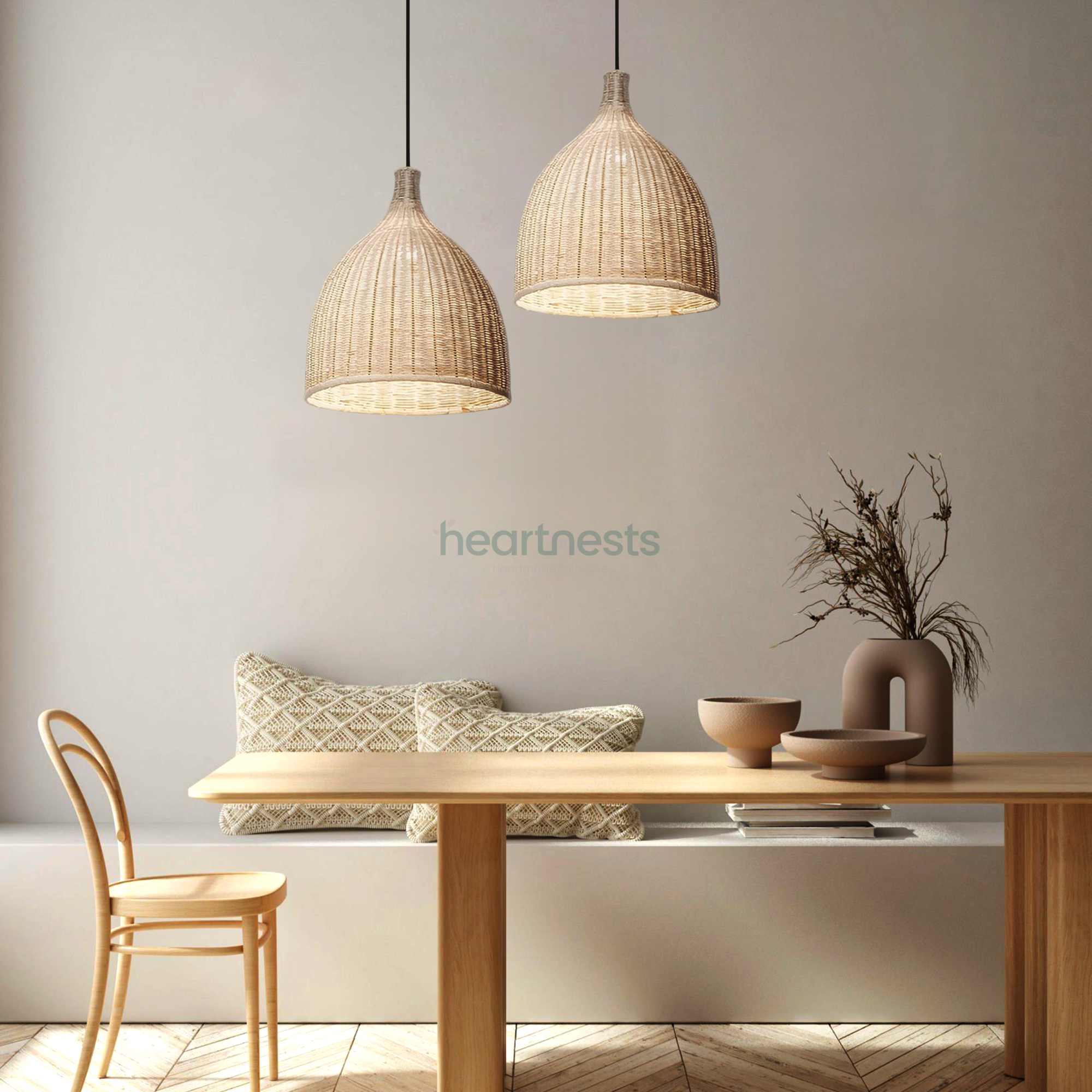 2 Baleria wicker hanging lights are hung side by side over a simplistic style wooden dining table with a wooden chair