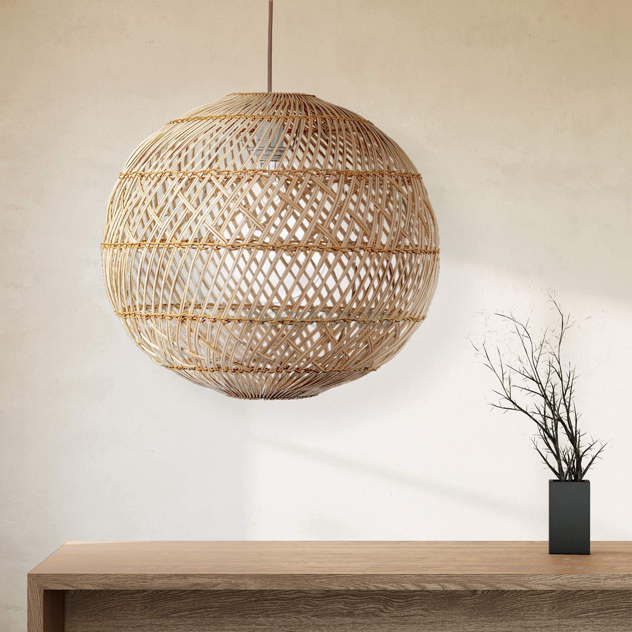 A Ballia round shape rattan pendant lights with lights on from brand Heart Nestsare hung above a wooden table in a close up view