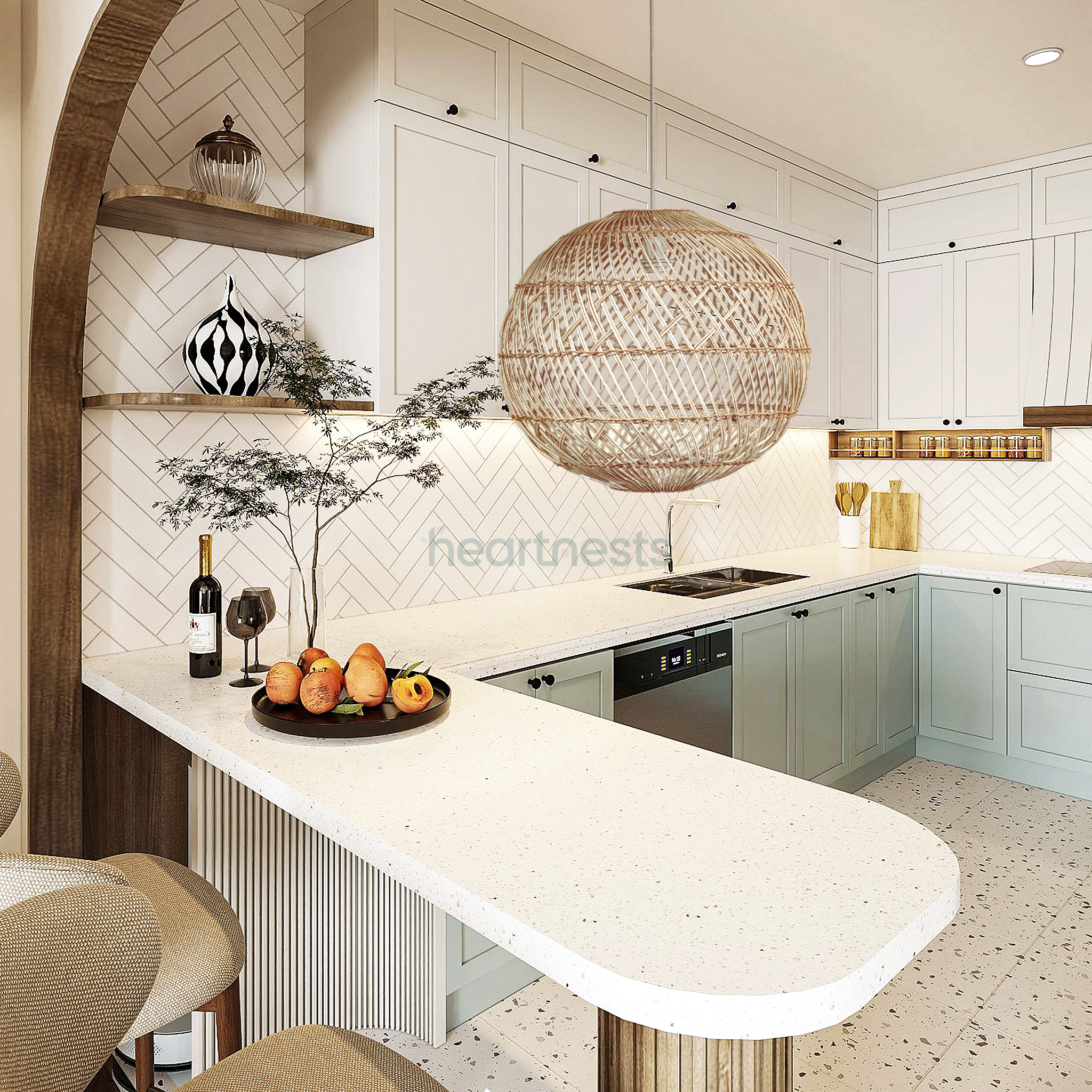 A Ballia round shape rattan pendant lights with lights on from brand Heart Nestsare hung above a modern organic white kitchen island