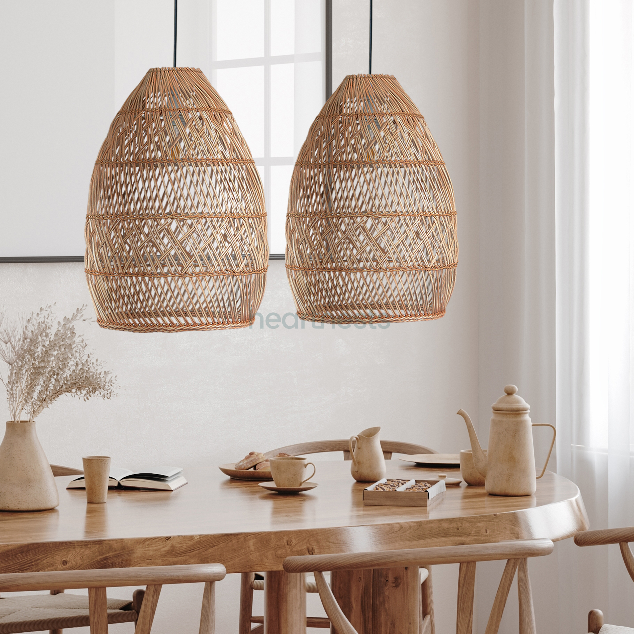 2 Brighton Rattan Pendant Light are hung side by side above a wooden dining table in a boho home decor setting