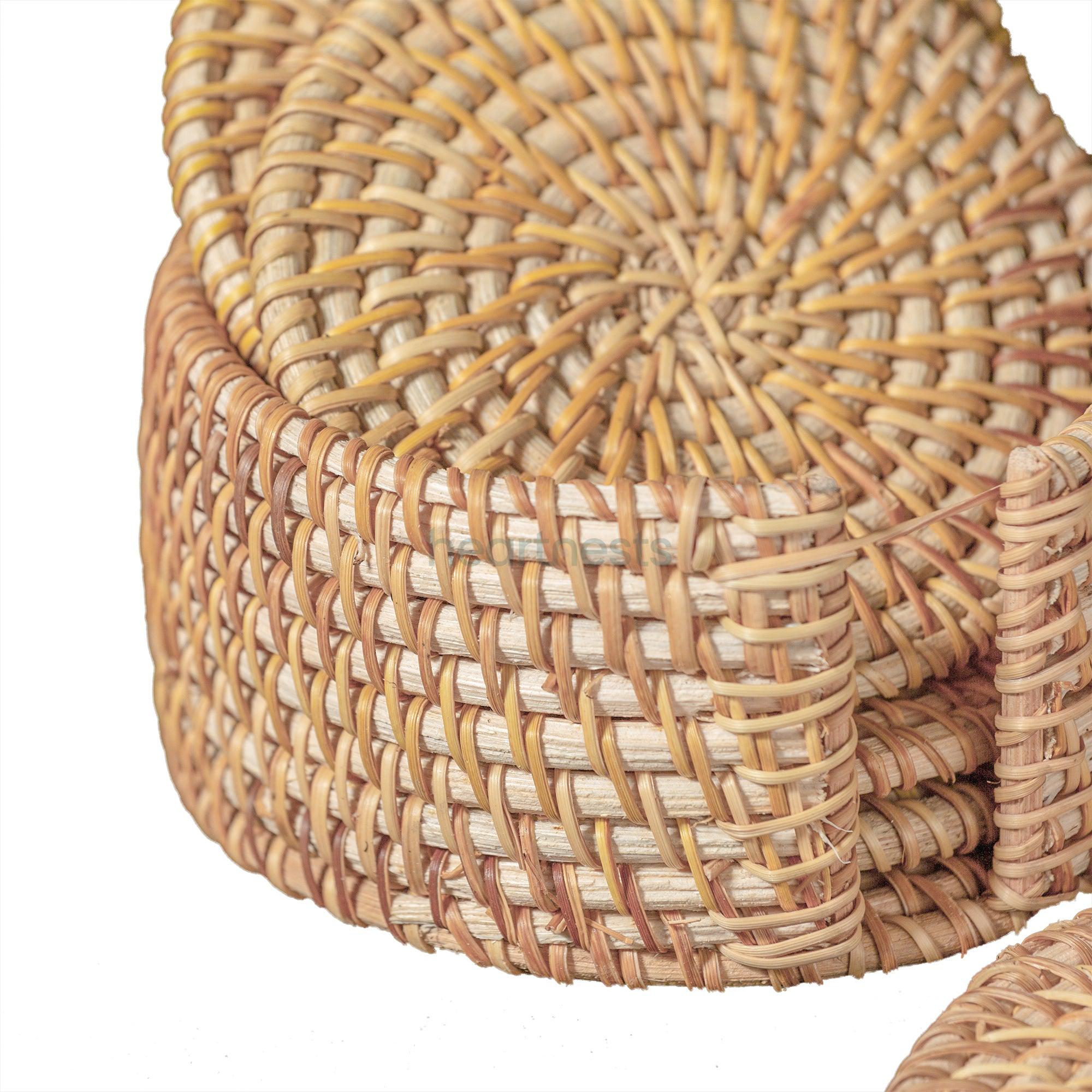 A close up view of Heartnests's Costella Rattan Coasters and coaster holder