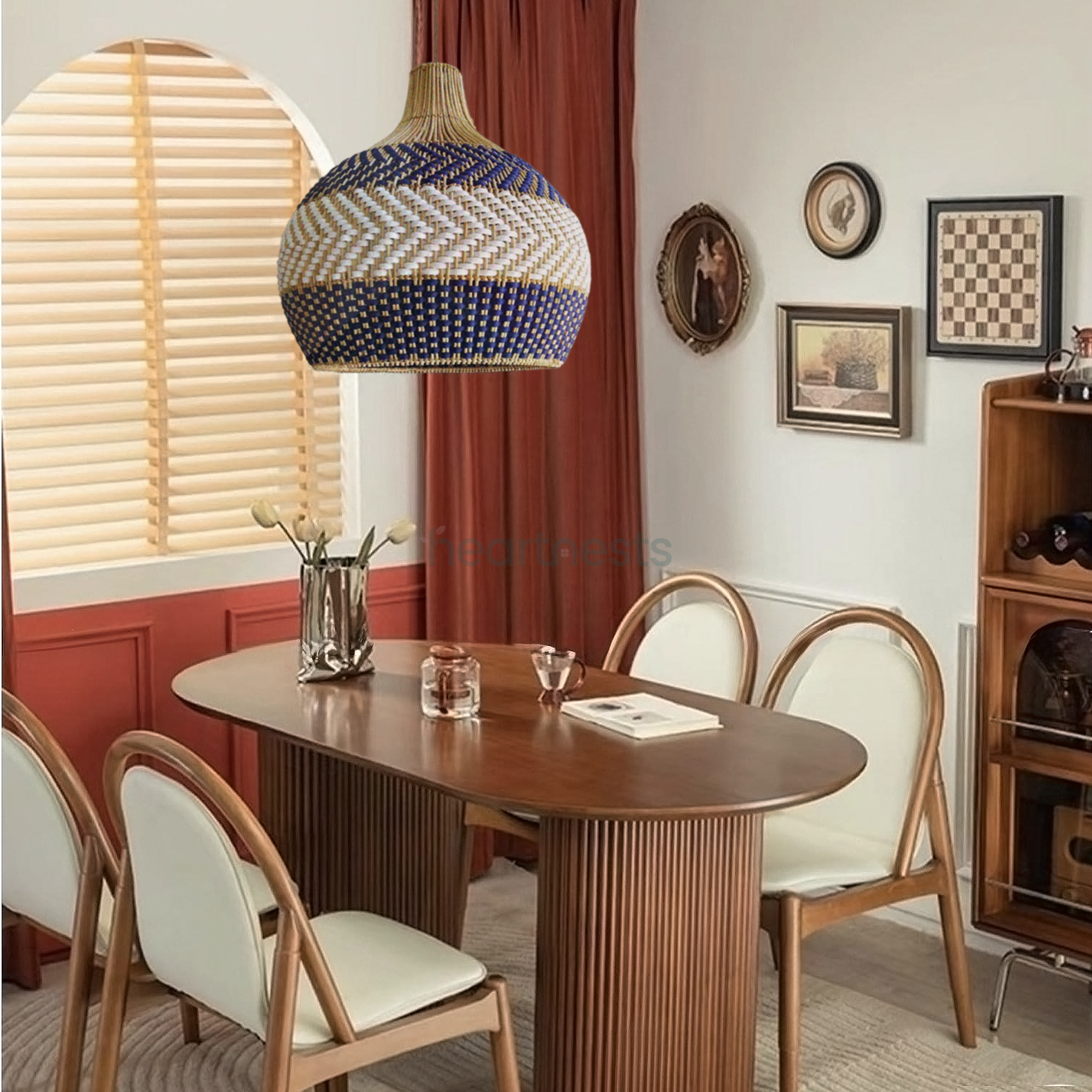 A Heartnests' Cosmo rattan pendant light is hung above a rattan dining room table with 4 rattan chairs