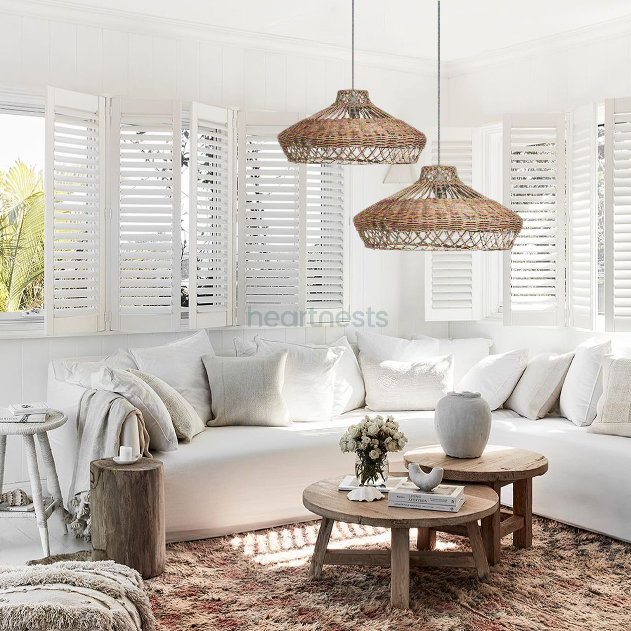 2 Heartnests' Pam Wicker Hanging Pendant Lights are hung above a coastal hampton style white sofa and a small wooden table in a coastal hampton style living room