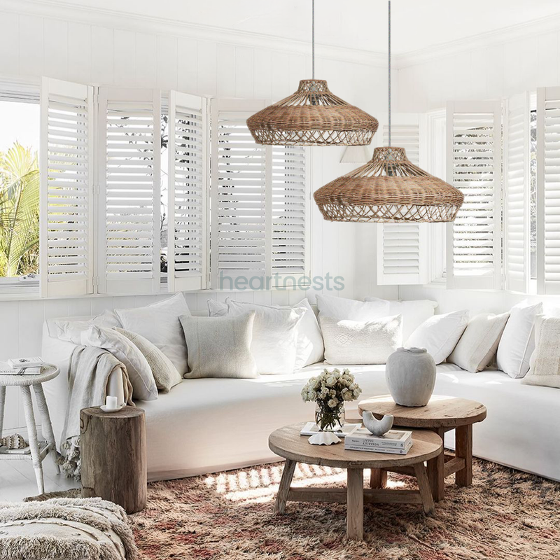 2 Heartnests' Pam Wicker Hanging Pendant Lights are hung above a coastal hampton style white sofa and a small wooden table in a coastal hampton style living room