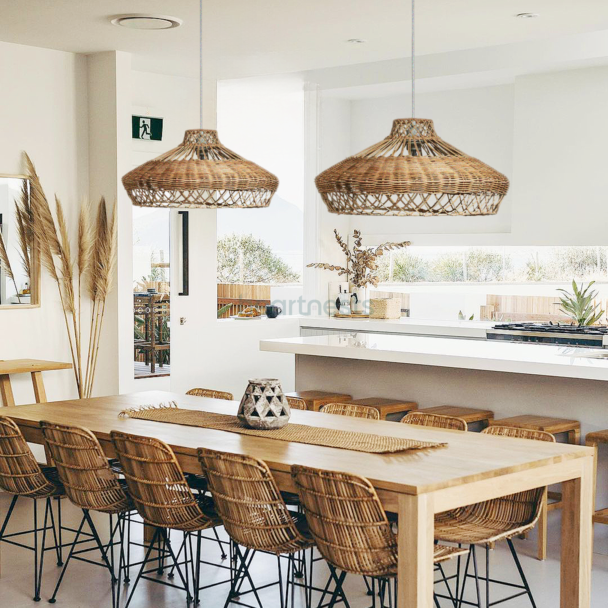2 Heartnests' Pam Rattan Lampshades are hung side by side above a wooden dining room with 3 rattan chairs in a boho minimalistic style kitchen