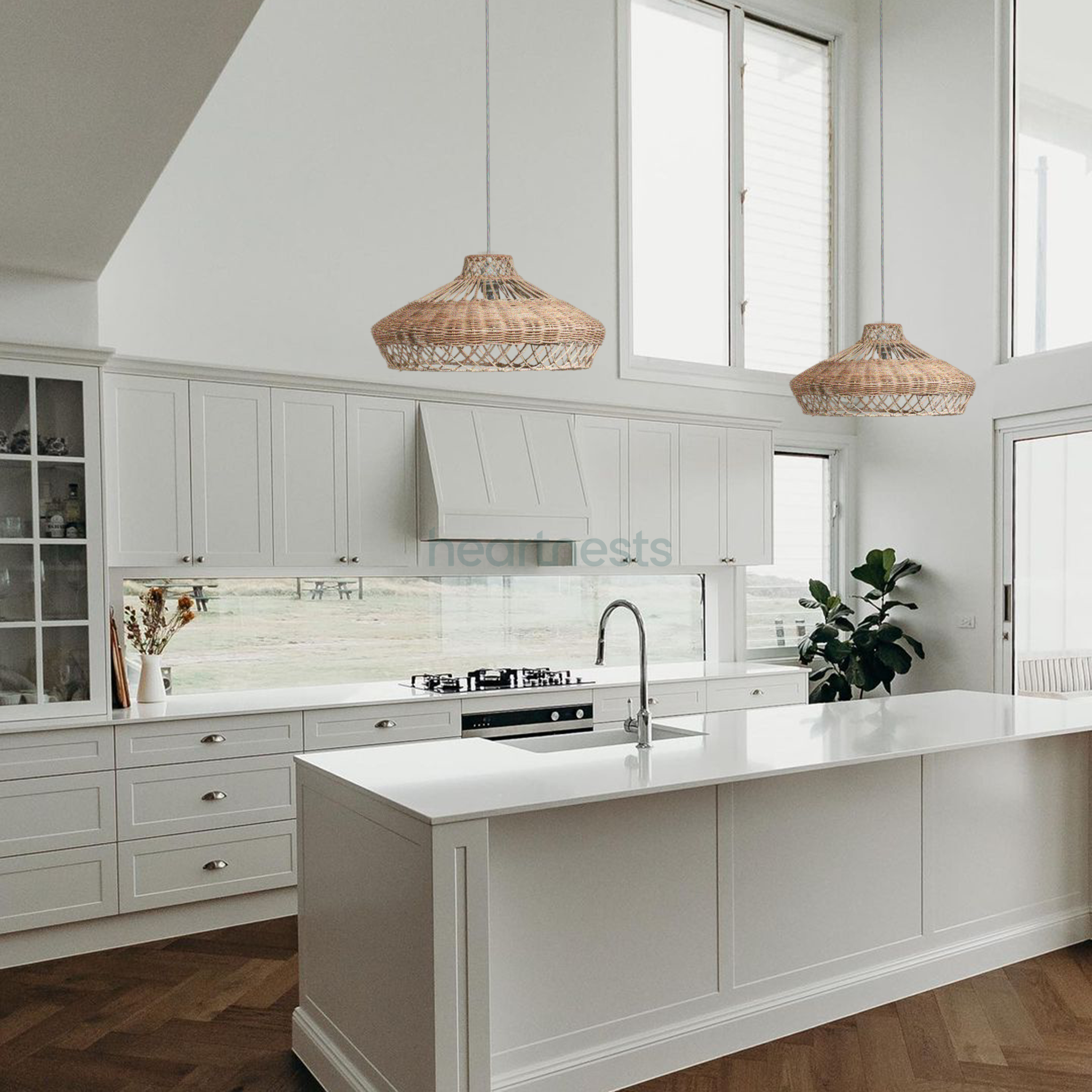 2 Heartnests' Pam Rattan Lampshades are hung side by side above a white kitchen island in a contemporary style kitchen