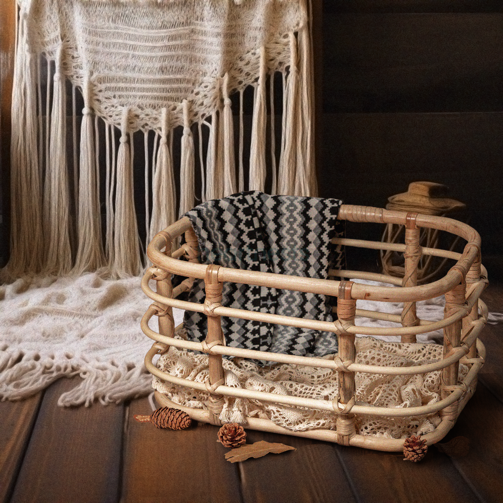 Heartnests' Peony Rattan Newborn Photography is on a wooden flooring in front of a wall hanging white macrame