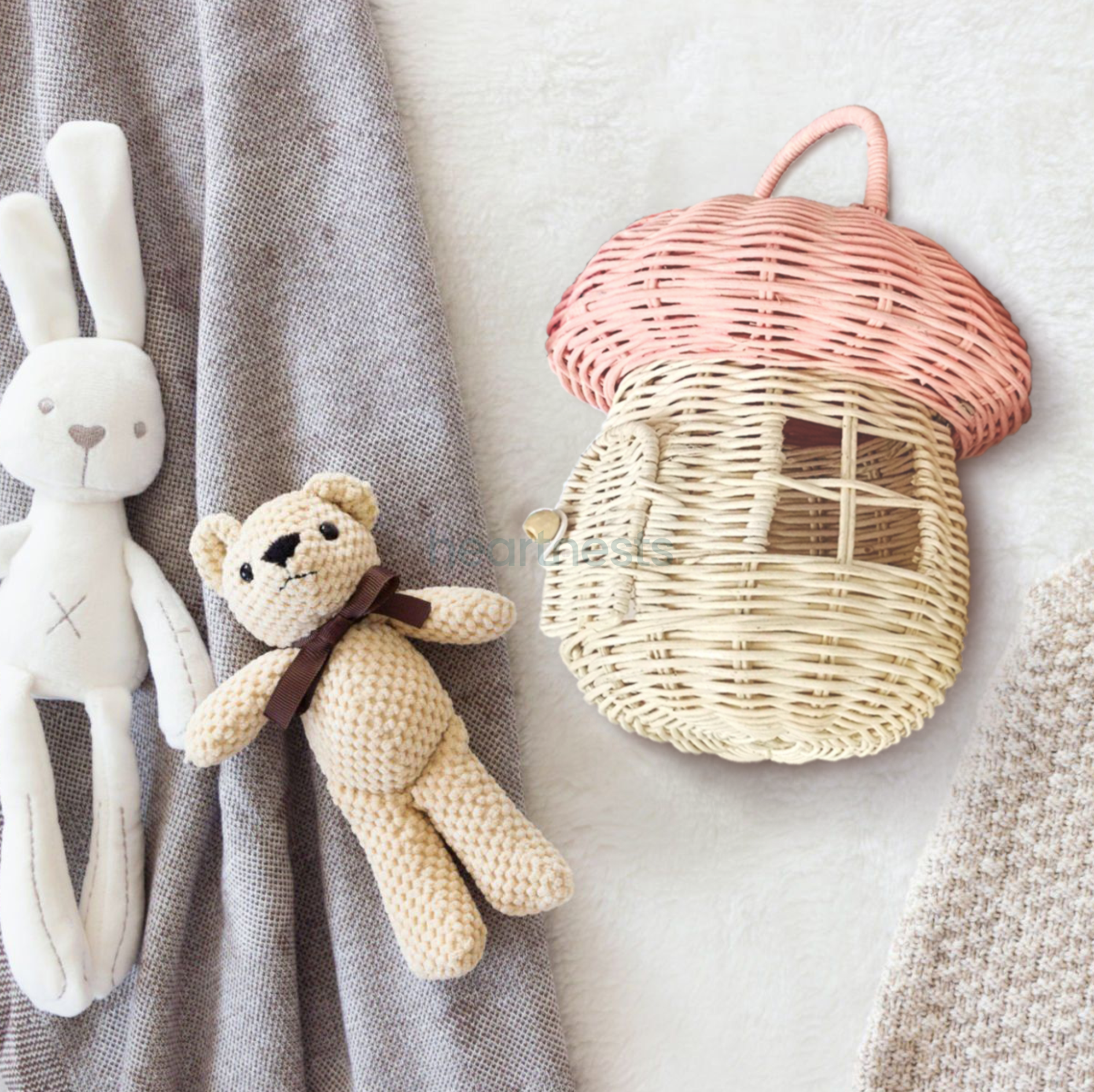 Heartnests' Pinky Rattan Mushroom lays next to 2 teddy bears
