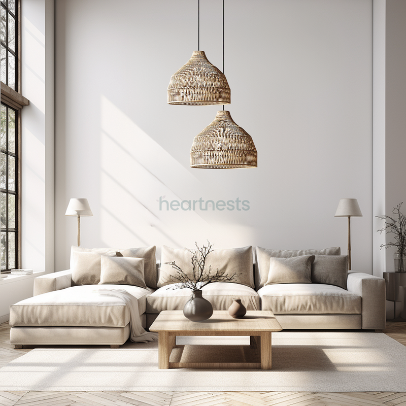 2 of Heartnests' Lombok Seagrass Pendant Lights are hung at different heights above a sandy color 5 seater L chase sofa and a wooden table in a Wabi sabi style living room