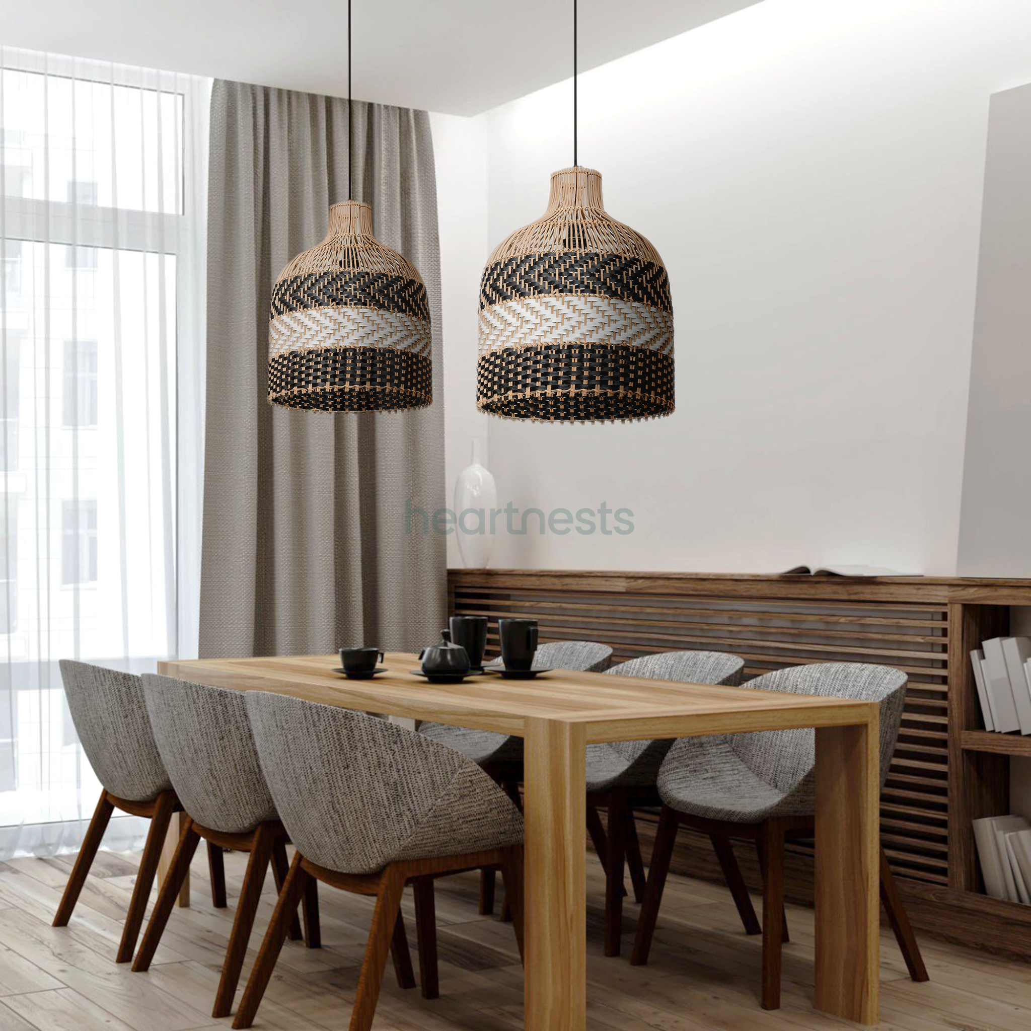 2 of Heartnests' Luka Rattan Hanging Lights are hung above a rectangular dining table with 6 light grey dining chairs