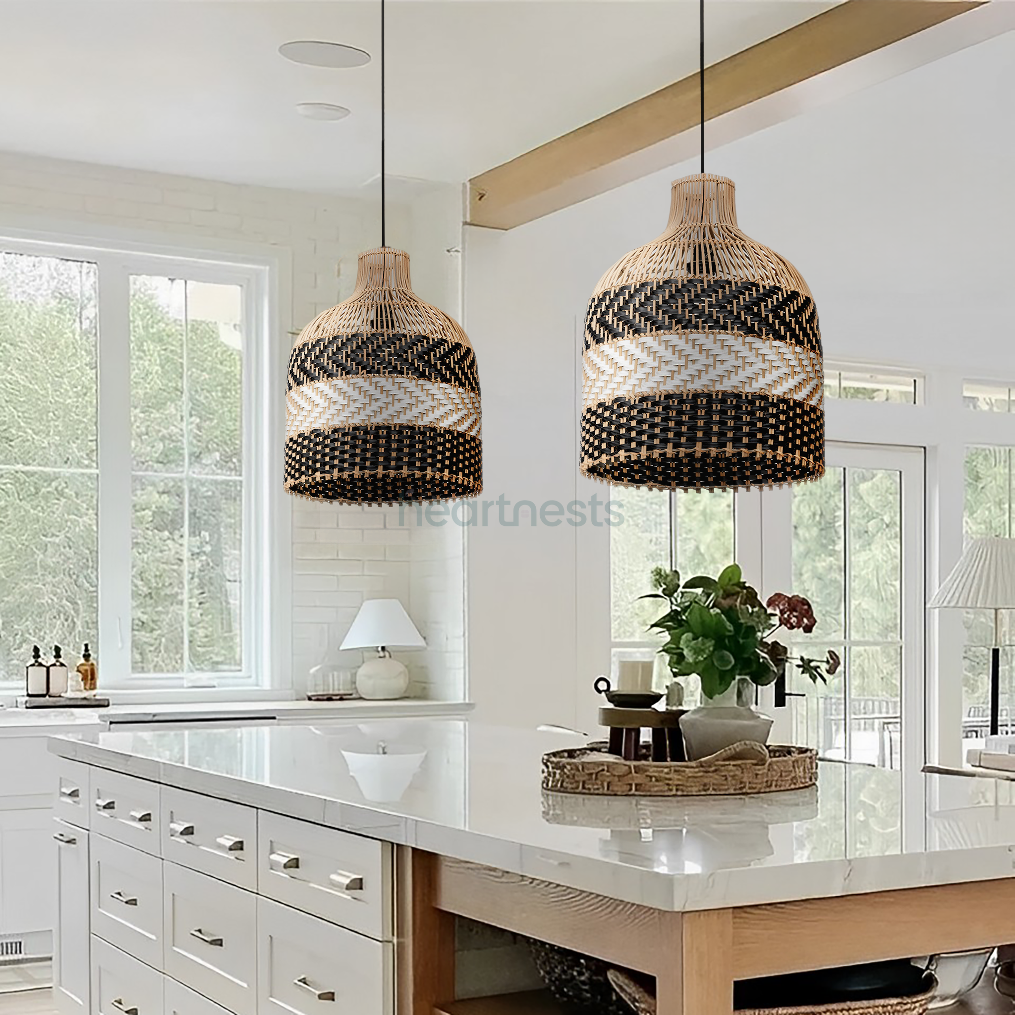 2 of Heartnests' Luka Wicker Pendant Lights are hung above side by side above a white marble top kitchen island in a Scandinavian style kitchen