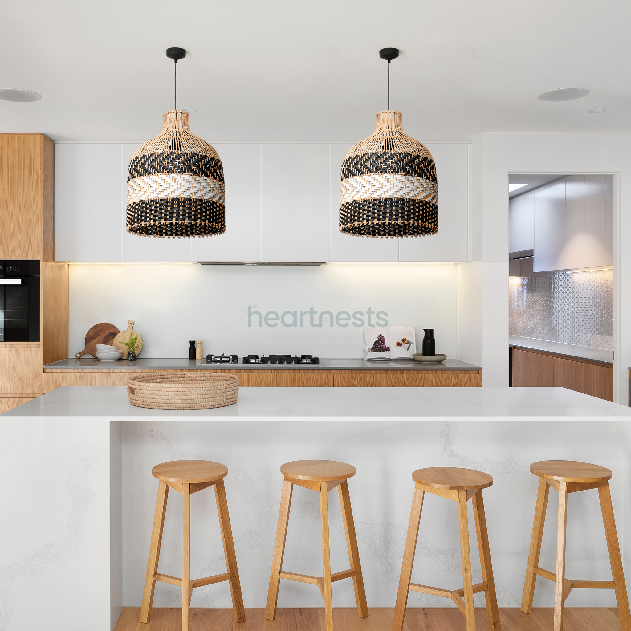 2 of Heartnests' Luka Rattan Lampshades are hung above a white kitchen islands and 4 natural wood colour kitchen stools in a Scandinavian contemporary style kitchen
