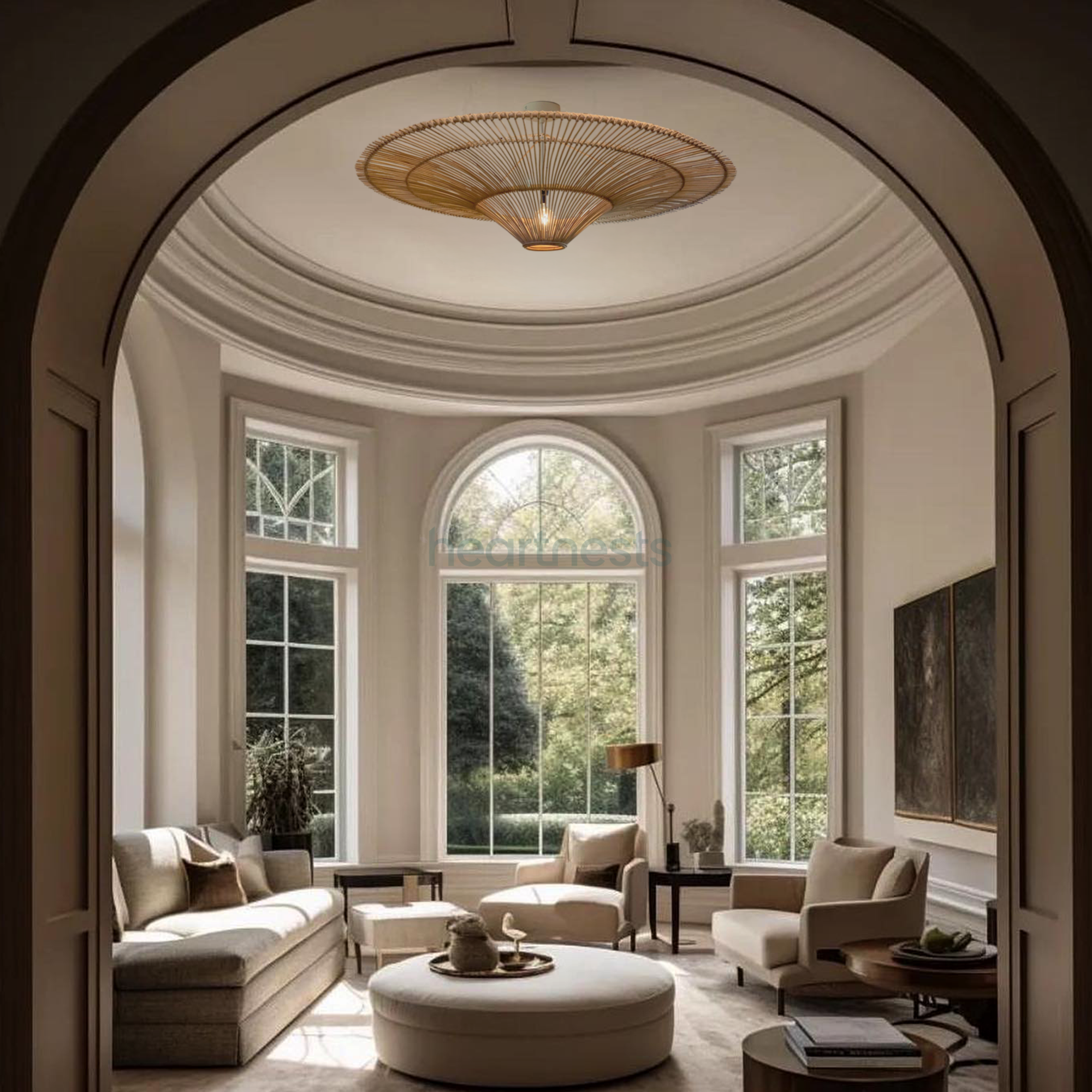 From an arch view, a Heartnests' Orbita Wicker Pendant Light is hung from a round ceiling and above a beige color chase sofa in a farmhouse style living room