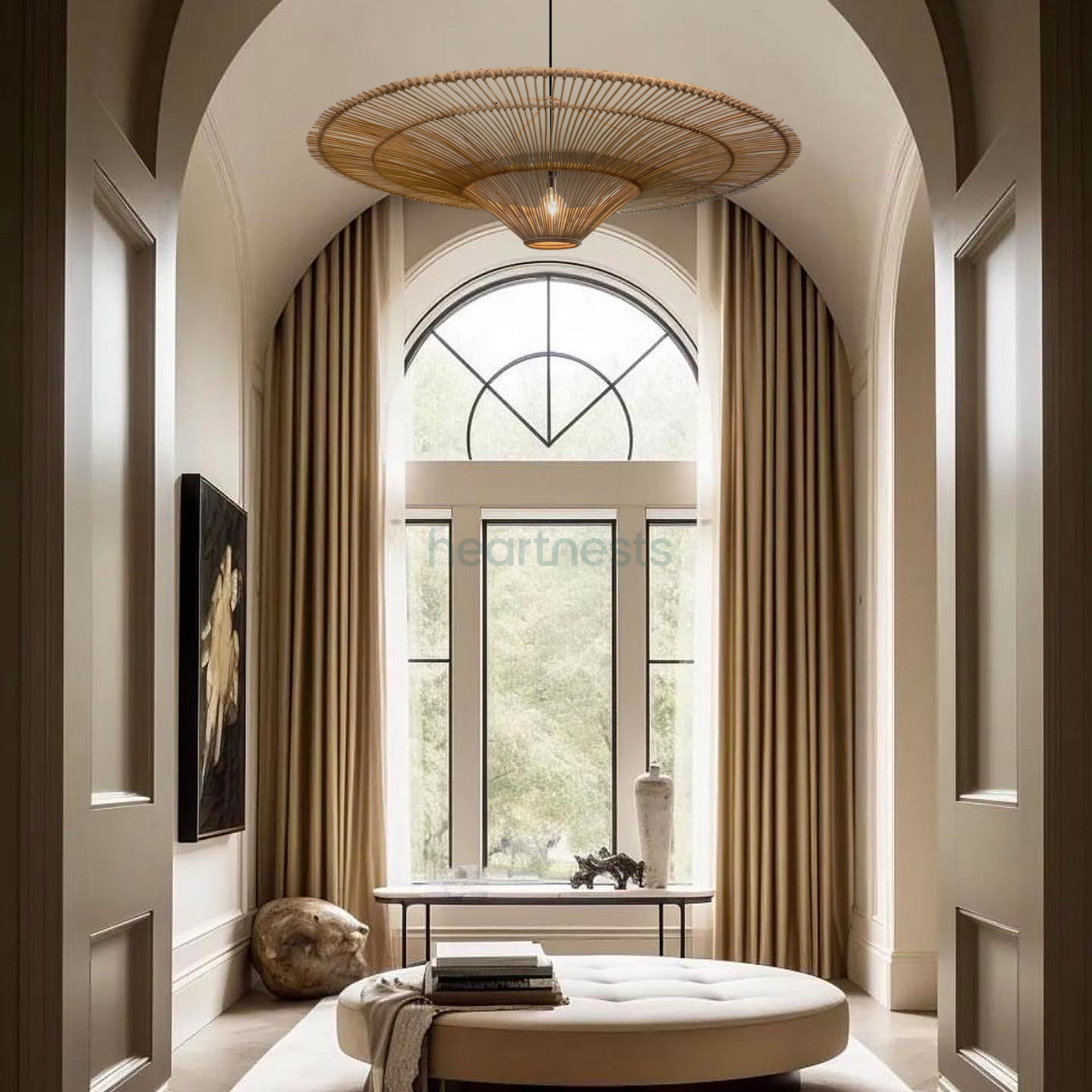 A Heartnests' Orbita Rattan Lampshade is hung above a beige ottoman in a farmhouse style living room