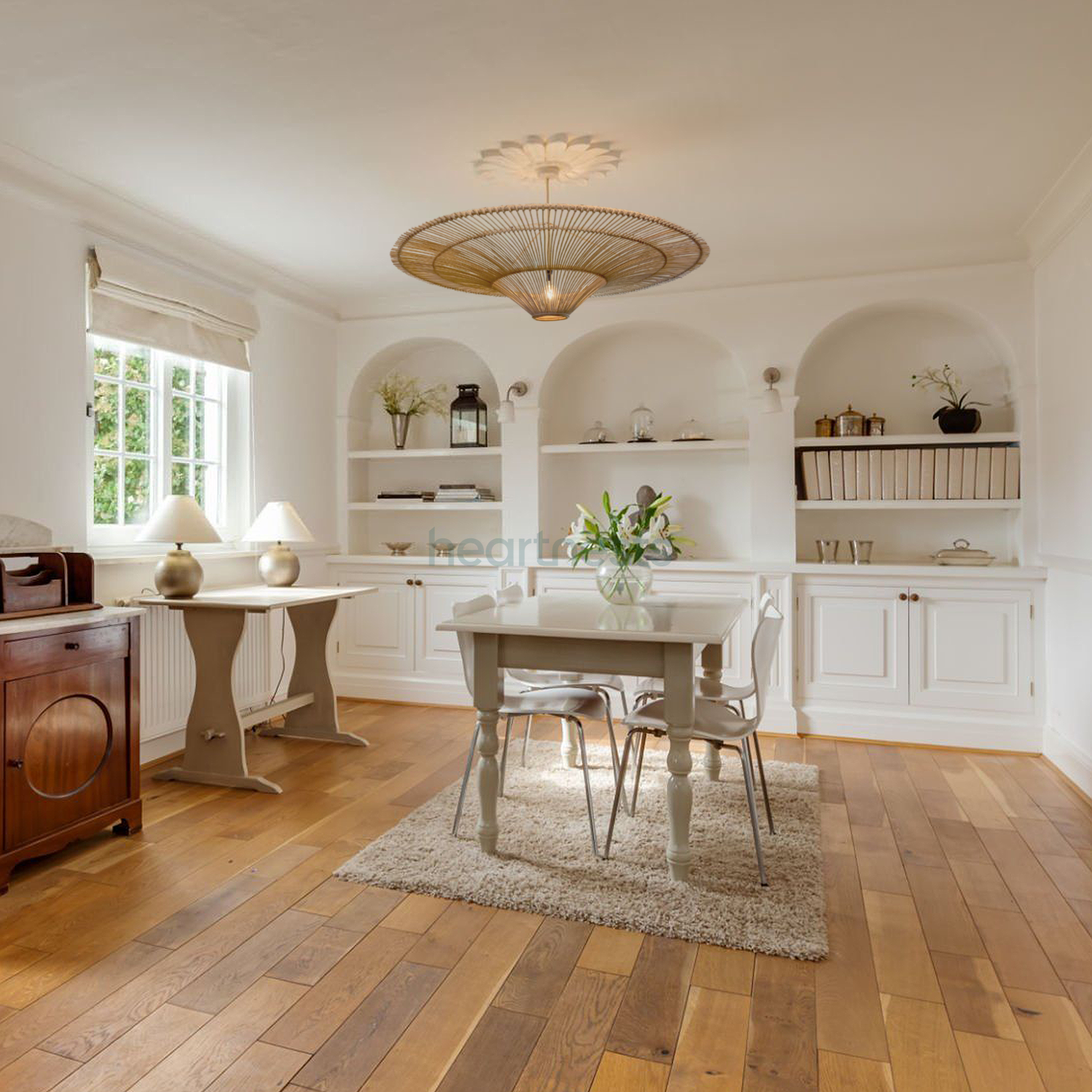 A Heartnests' Orbita Wicker Hanging Pendant Light is hung above a wooden kitchen island in a country style kitchen area