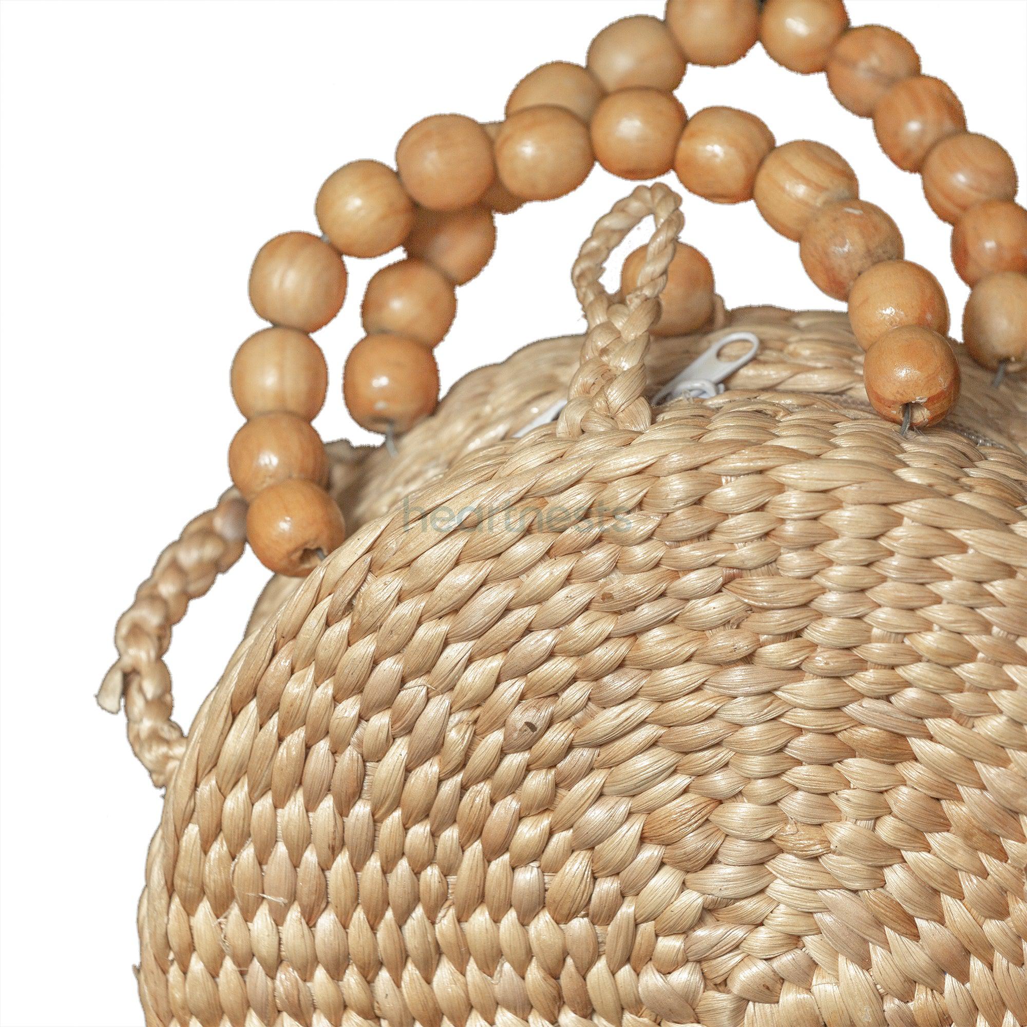 A close up view of wooden beaded handle of Reena Handbag Fashion Bag