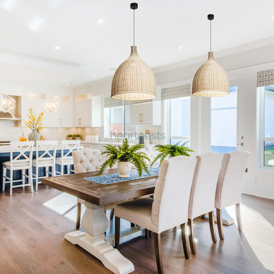 2 of Heart Nests's Baleria Rattan hanging lights are hung side by side over a wooden dining table with 6 modern dining chairs