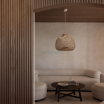 A Bali wicker pendant light is hung above a table in a minimalistic decor room