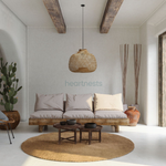 A Bali bamboo hanging light is hung above a set of 3 seater sofa and a wooden table in a farmhouse style living room