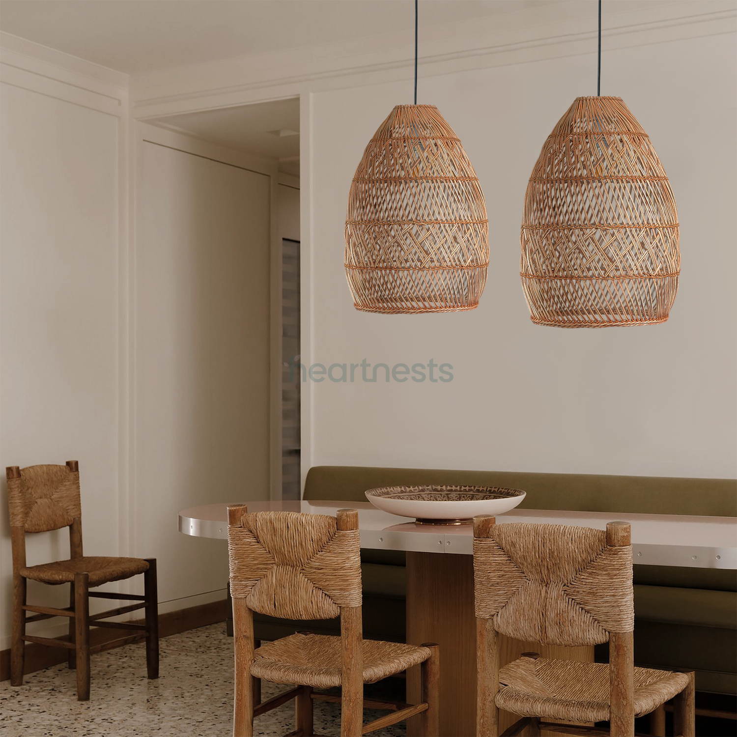 2 Brighton Rattan Pendant Light are hung side by side above a wooden dining table with 2 rattan dining chairs in a boho home decor setting