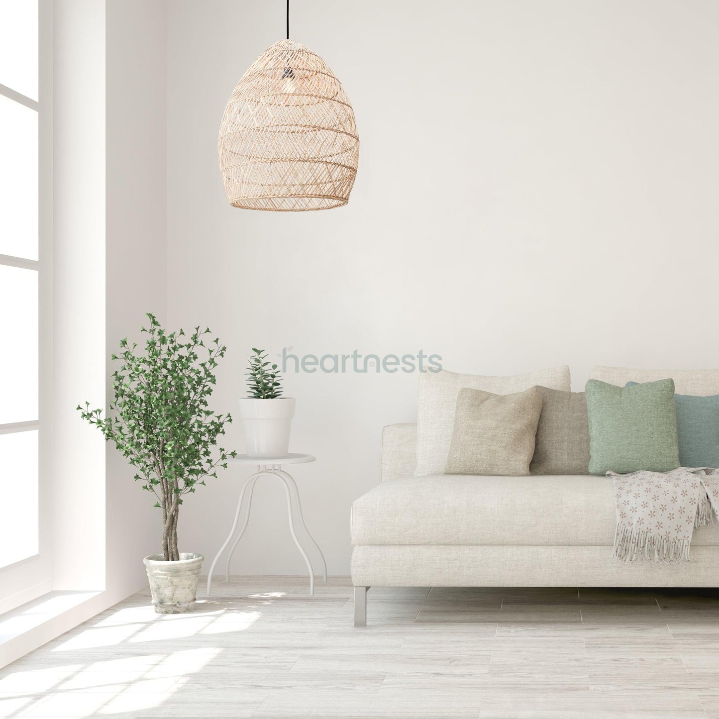 A Brighton Rattan Pendant Light is hung above a gray sofa and a green pot plant