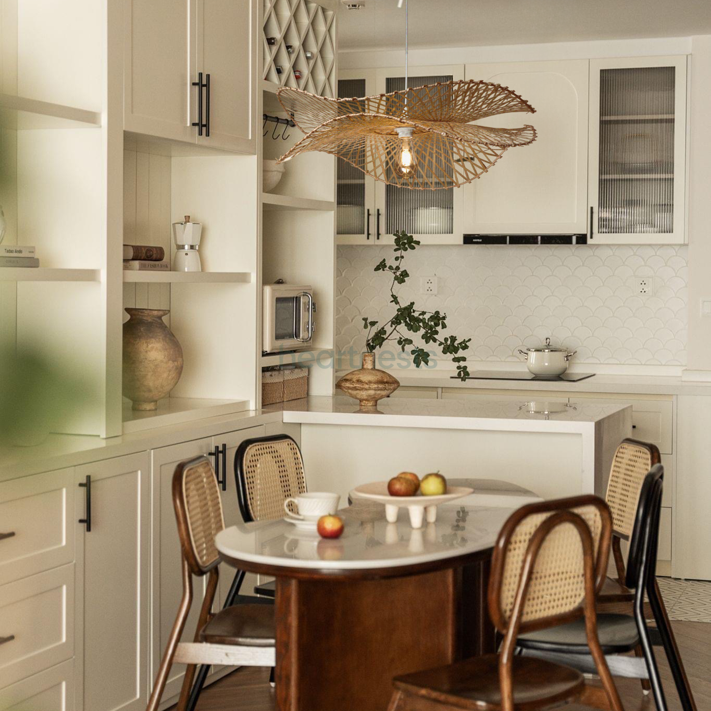 A Heartnests's Correa Bamboo Pendant Light is hung above a dining table in a minimalistic room decor setting