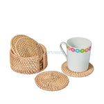 An arrangement of a  white glass placed on a Heartnests's Costella Rattan Coaster next to a coaster holder