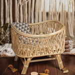 Heartnests's Cra Baby Prop for baby photography on a wooden floor and its background is a white macrame