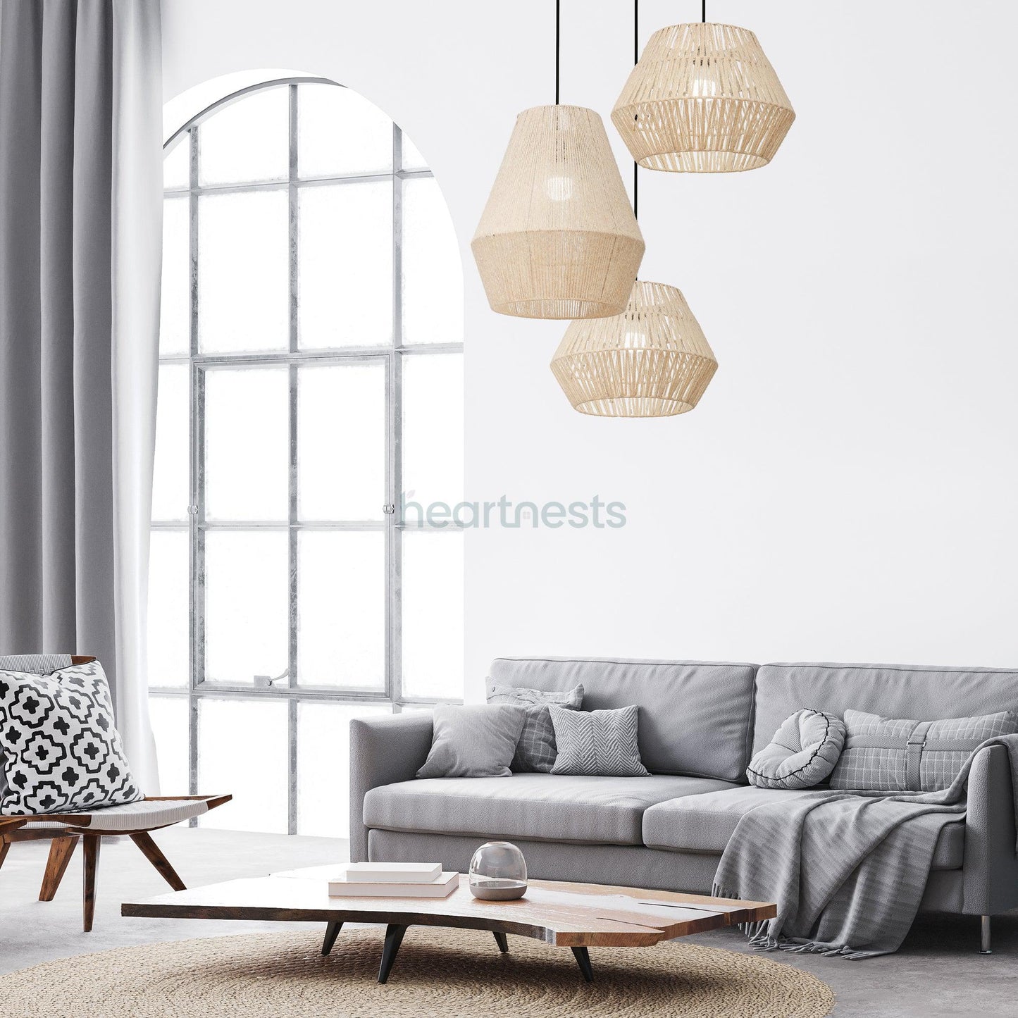 A Cluster of 1 Heartnests's Long Diamond Jute Hanging Light and 2 of Short Diamonds Jute Pendant Lights are hung above a wooden living table and grey lounge in a contemporary living room setting