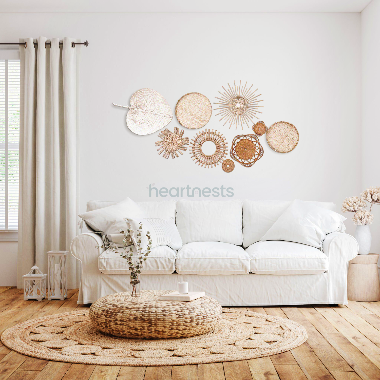 A set of Heartnests' 9 Freiya rattan and seagrass wall decor is hung above a white 3 seater lounge and a rattan ottoman in a modern bohemian living room