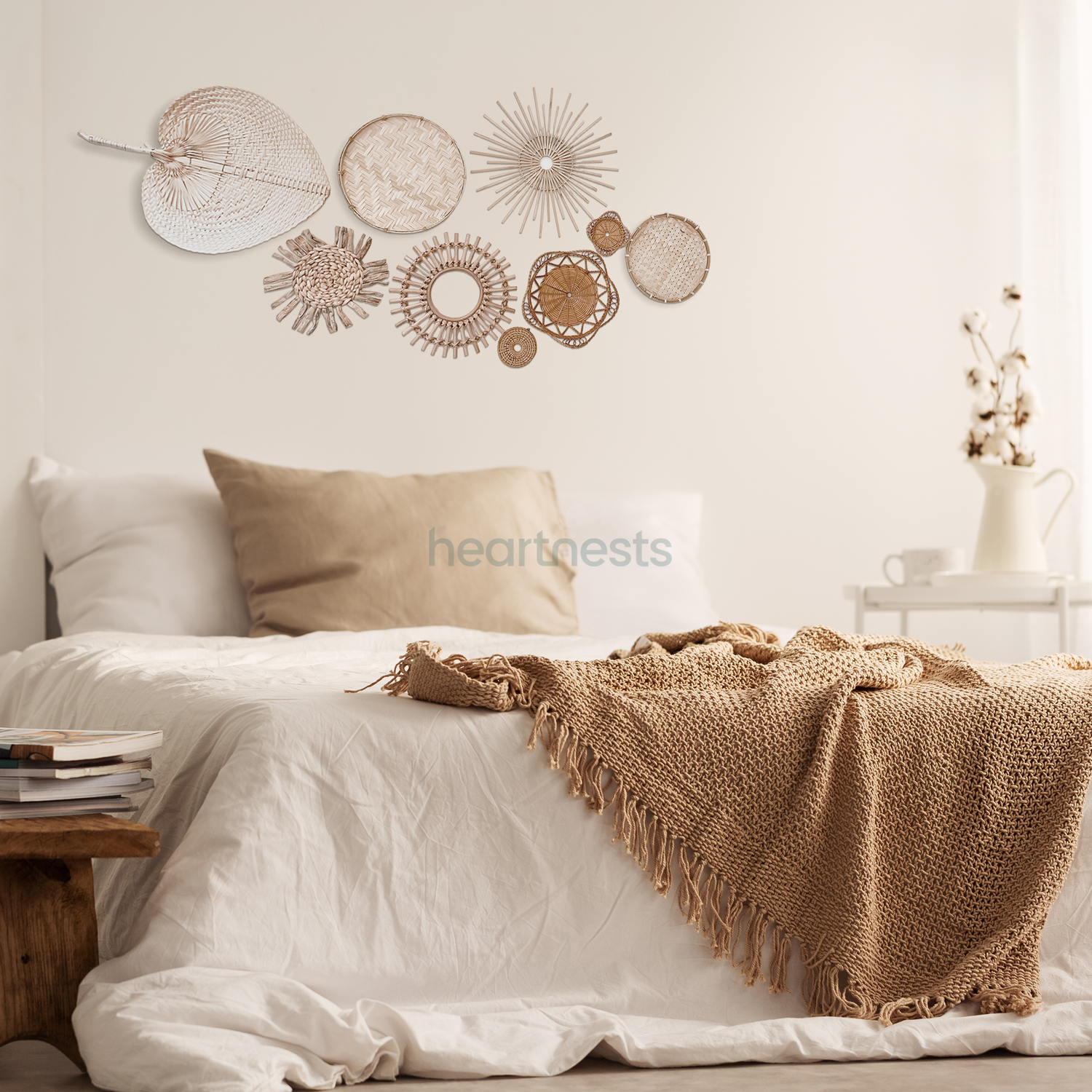 A Heartnests' set of 9 Freiya rattan and seagrass wall decor is hung above a rattan bed with white and brown color bed sheet and quilt cover