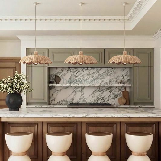 3 Isle rattan pendant lights from Heart Nests hung side by side featured flower shape are hung above a long white marble top kitchen island with 4 white kitchen stools following trendy modern organic interior style