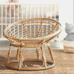 A Heartnests' Molisa Rattan Baby Parpasan Chair for Newborn Photography is on a wooden floor of a nursery