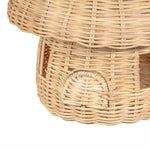Zoomed in front part of a Heartnests' Malia Rattan Mushroom showing 2 windows and 1 door of the mushroom house
