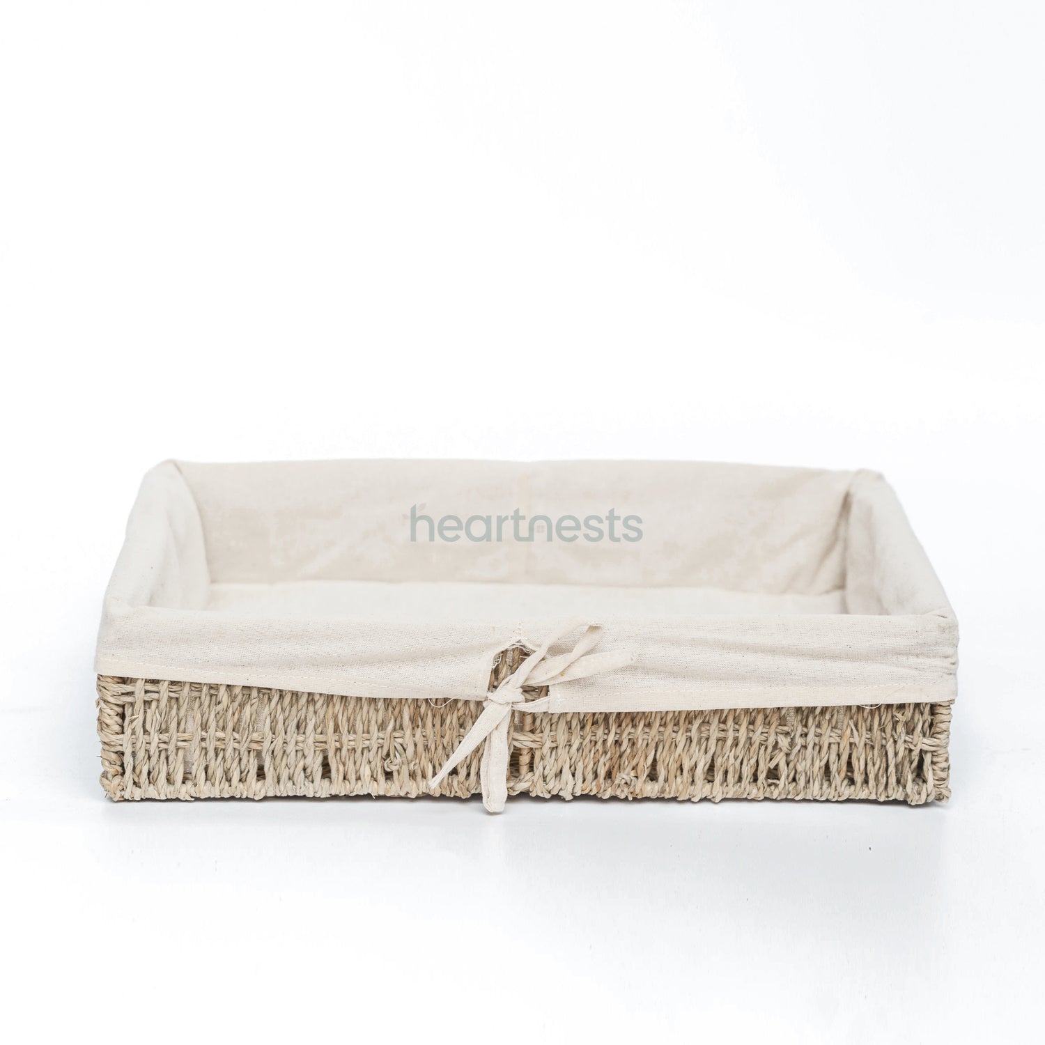 A Heartnests' Mimi Seagrass Storage Basket in rectangular shape with cotton beige color liner is on white background