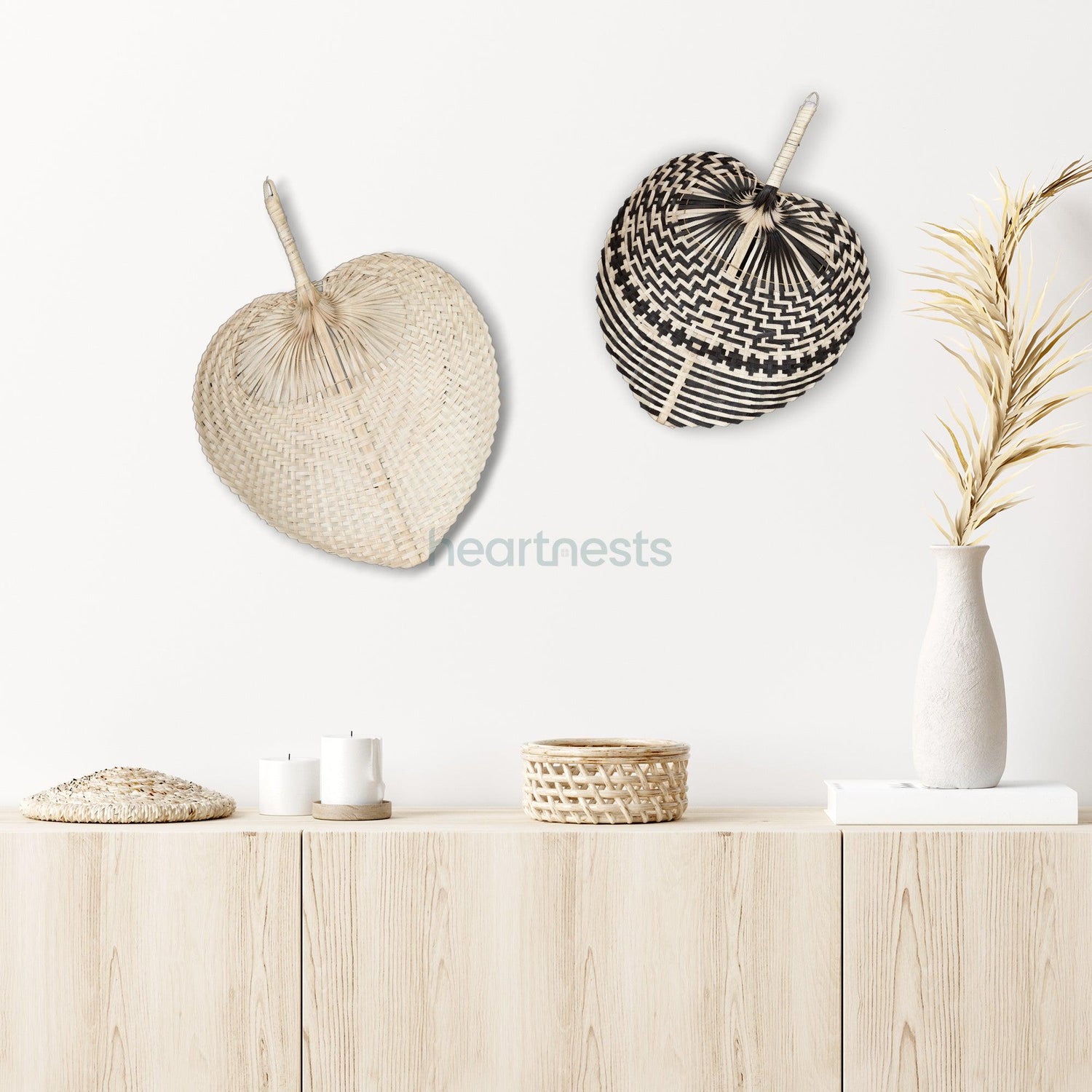 2 of Heartnests' Fan Wall Decor, 1 in beige color, the other is with black stripes, both hung next to each other and above a light wash wooden console table