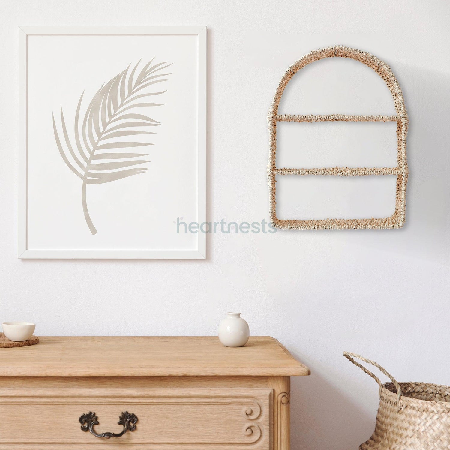 Heartnests' Raina Wall Organiser is hung on a wall next to a leaf painting above a wood console table