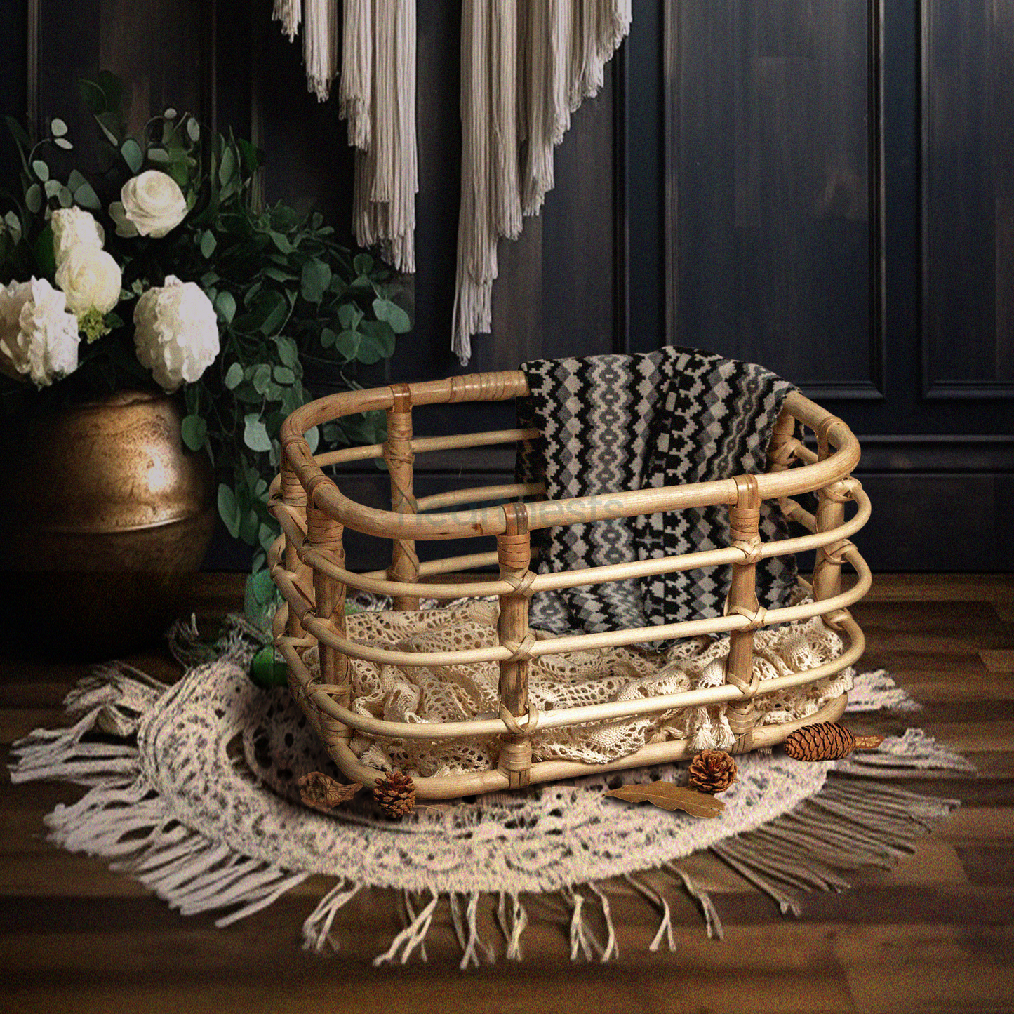 Heartnests' Peony Rattan Baby Photography is on a white macrame on a wooden flooring next to white flower vase, against a dark tone wooden wall