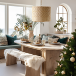 A Heartnests' Lifa Wicker Pendant Light is hung above a wooden table and a wooden bench next to a Christmas tree