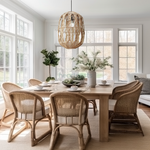 A Heartnests' Malee Rattan Pendant Light is hung above a rectangular wicker living room table and 6 rattan chairs in a coastal style living room
