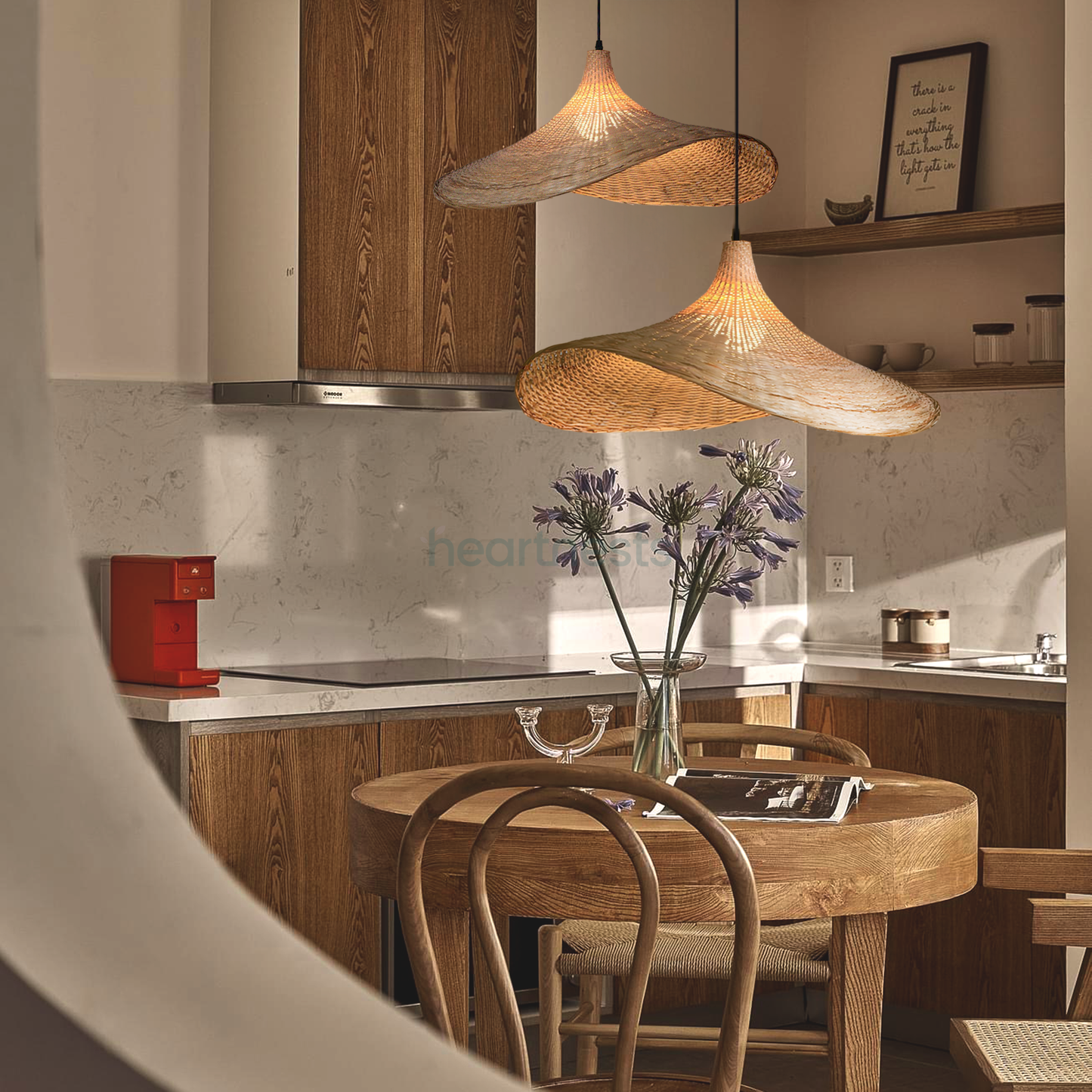 2 of Heartnests' Mexica Wicker Hanging Lights are hung at different heights above a small dining table with 1 wooden chair in a bohemian style small kitchen area