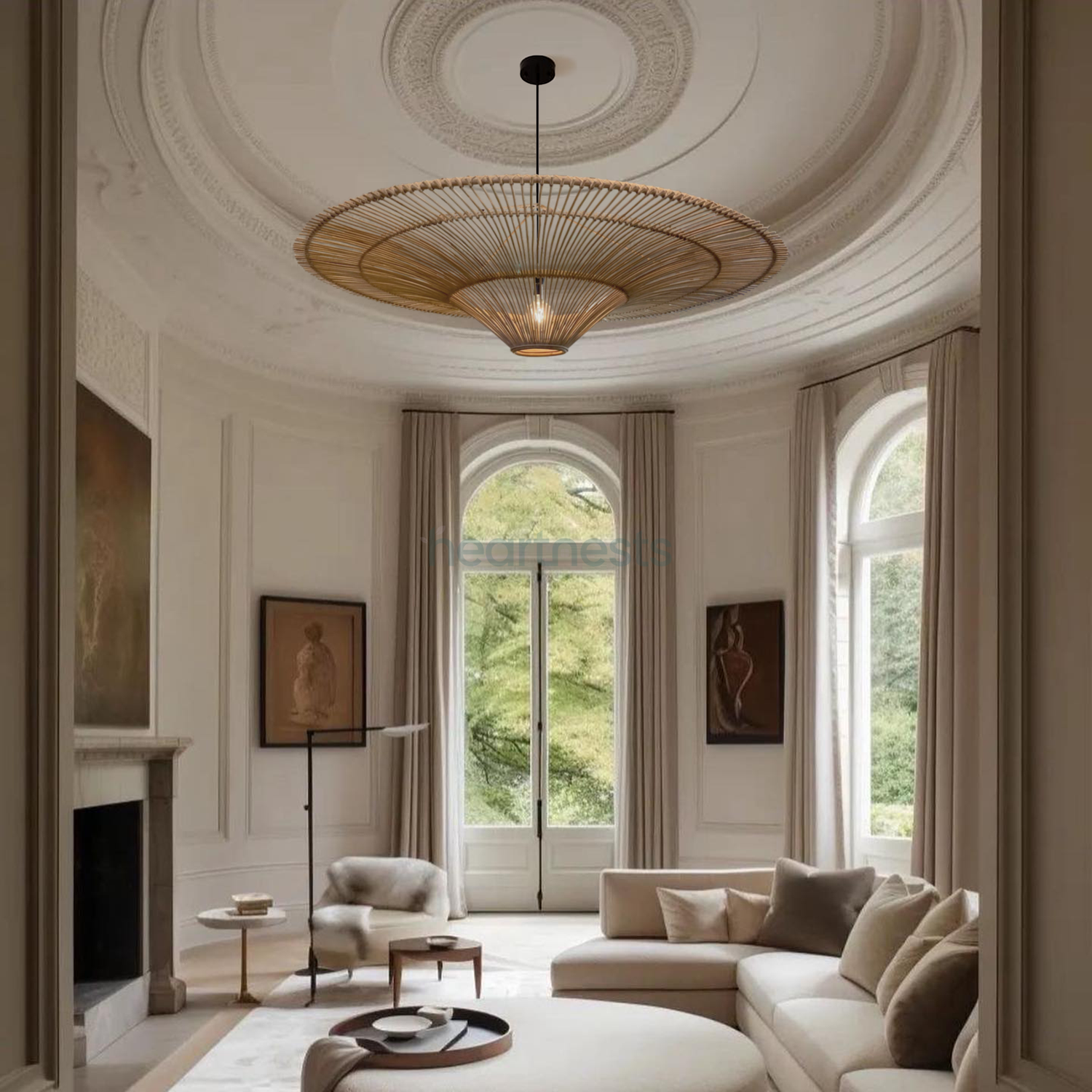 A Heartnests' Orbita Rattan Pendant Light is hung from a round ceiling and above a beige color chase sofa in a farmhouse style living room