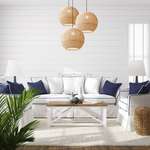 3 of Heartnests' Preethy Rattan Hanging Lights are hung in clutter dropped down in different heights from ceiling to a round white living table in a contemporary style living room