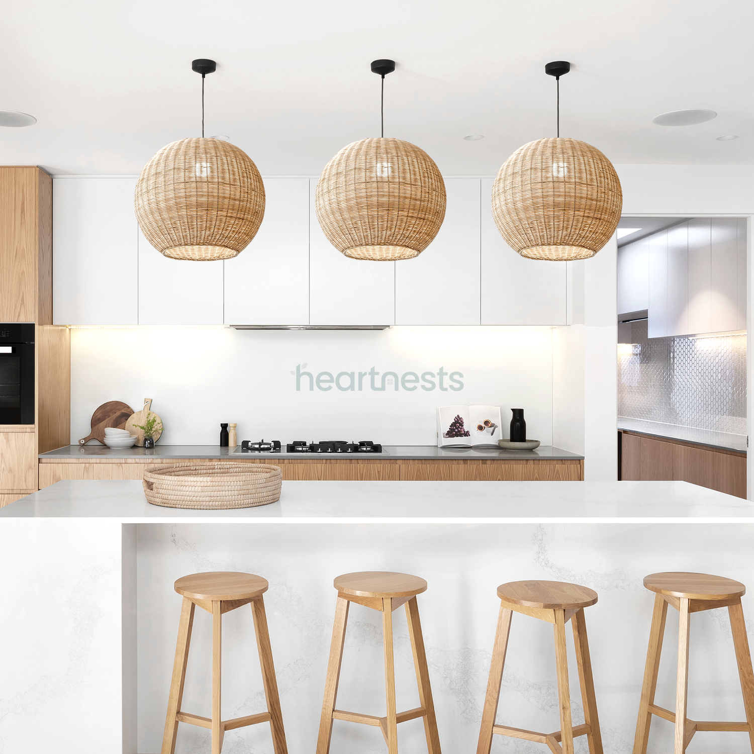 3 of Heartnests' Preethy Rattan Hanging Lights are hung above a white marble kitchen island and 4 rattan chairs in a contemporary kitchen 