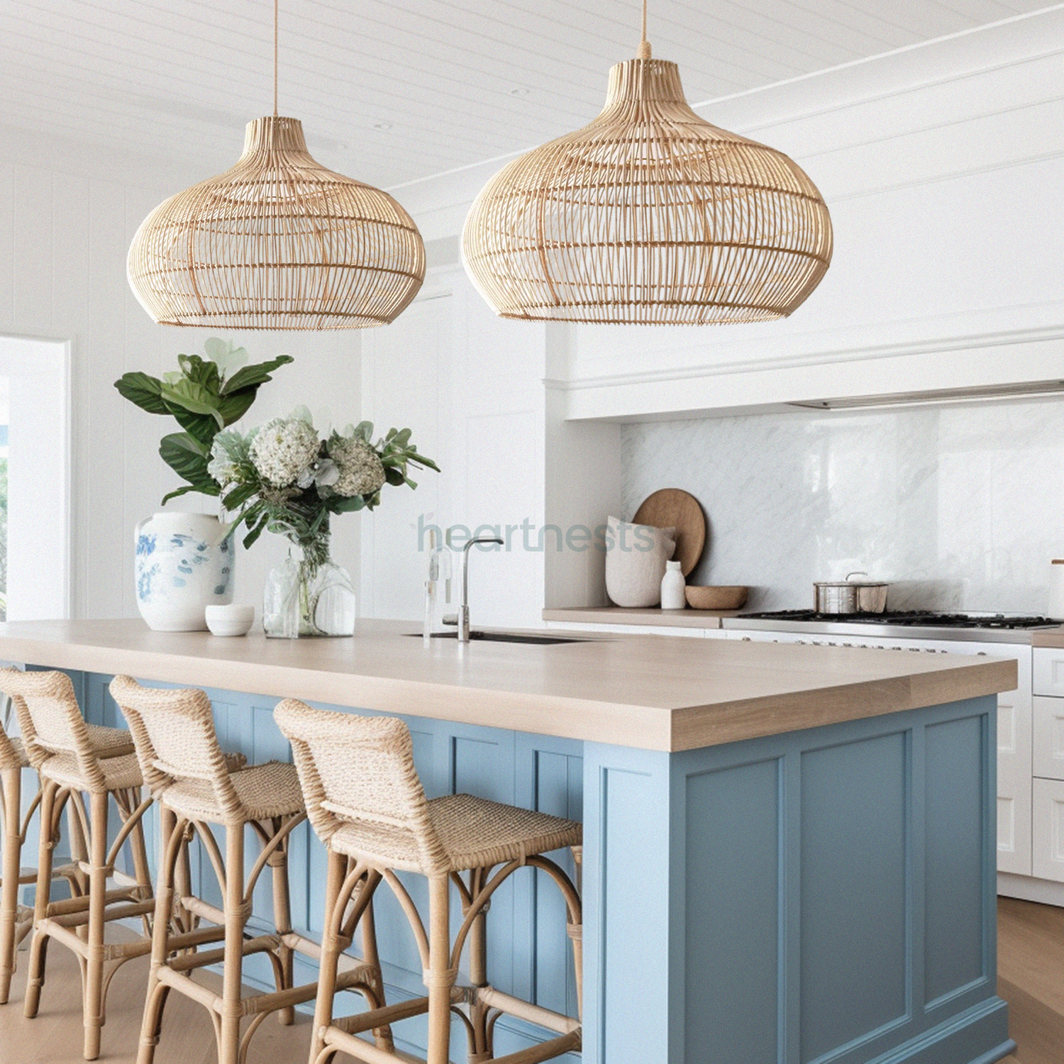 2 of Heartnests' Santa Barbara Wicker Pendant Lights are hung above a blue hue kitchen island with 3 rattan chairs